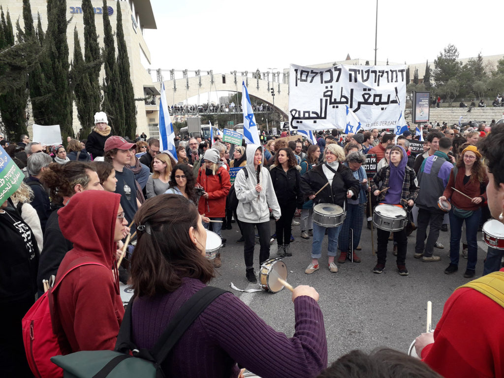 Demonstration against the legislative reform, Jerusalem, February 13, 2023. The big sign reads: “Democracy for all” in Hebrew and Arabic.